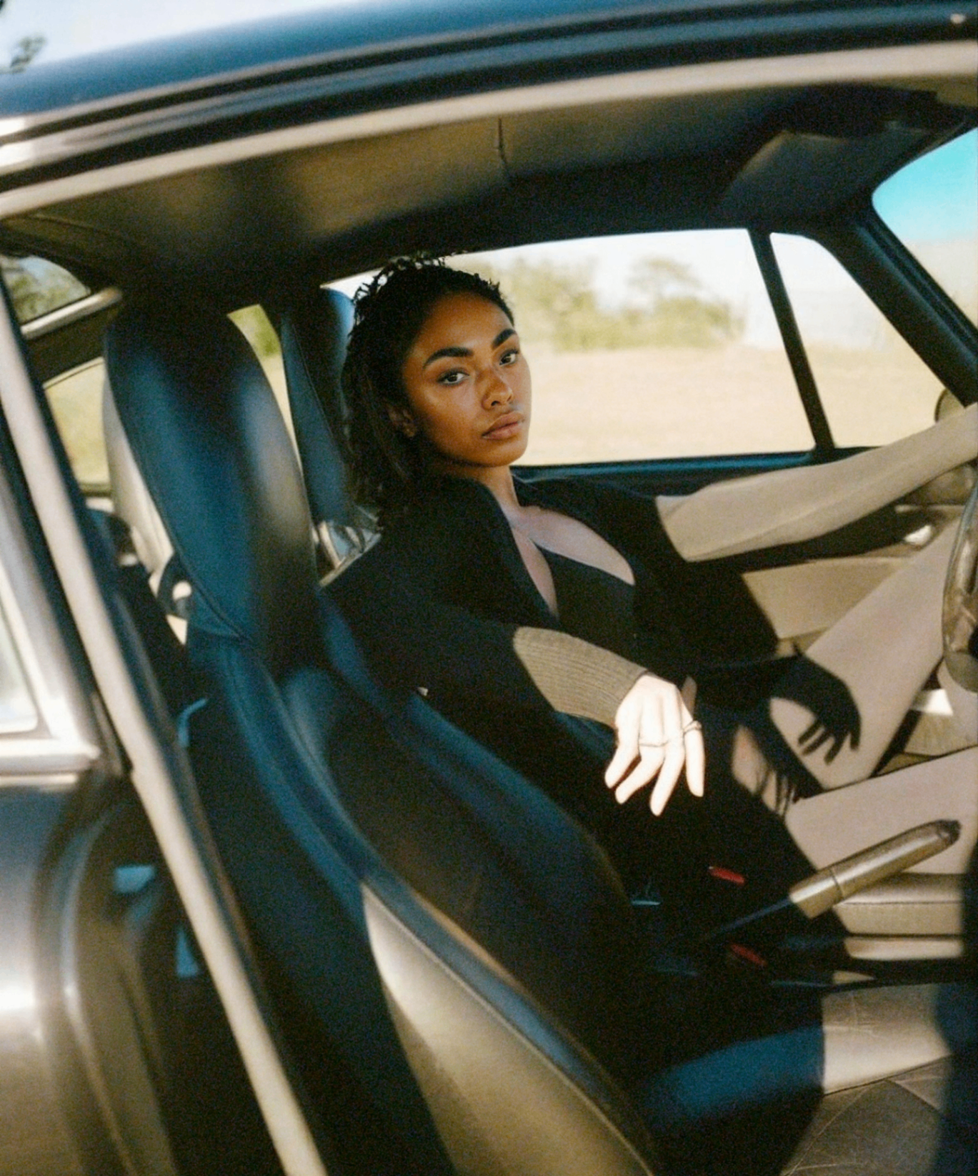 Cielo in the passenger seat of a vintage Porsche — cinematic California light and the art of living beautifully